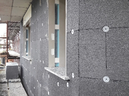 Dettaglio di una facciata con installazione di fissaggi ETICS
